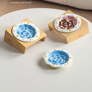 Dettaglio di ciotole anti-ingozzamento in ceramica per animali con supporti in bambù.