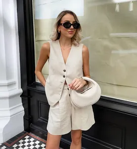 Chic khaki cotton-linen vest and shorts set styled with a white bag and sunglasses