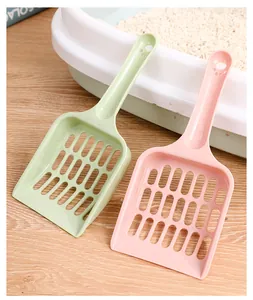 Close-up of macaron pink and green cat litter scoops with hollow grid design for cleaning