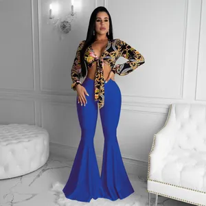 Sexy two-piece set featuring a baroque print tie-front crop top and blue flare pants