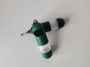 Portable pet travel multi-functional soap and waste bag dispenser in green and black.