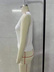 Side profile detail of a white sleeveless knit vest with ribbed hem and armholes