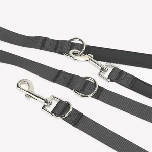 Close-up of durable black nylon dog leash with heavy-duty metal snap hooks and rings