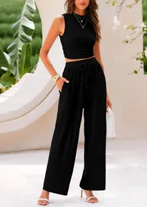 Close-up of elegant black knit two-piece set featuring sleeveless top and wide-leg pants