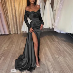 Elegant floor-length black evening gown with sequin sleeves and high leg slit detail