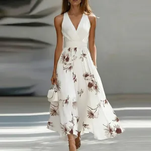 Elegant white maxi dress with brown floral print, deep V-neck, and sleeveless design.