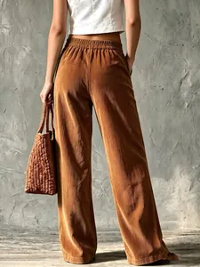 Back view of vintage high-waisted brown corduroy wide-leg trousers with elastic waistband.