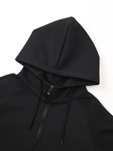 Close-up of black sports zip-up hoodie showing hood and zipper detail