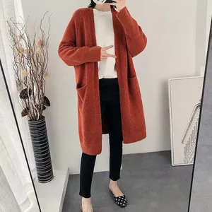Full-length view of a mid-length thick knitted cardigan sweater for women in orange.