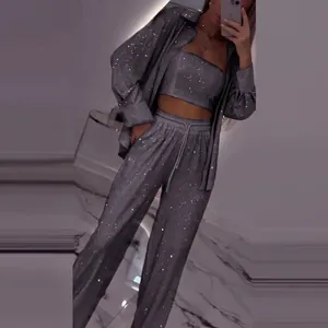 Mirror selfie detail of women's sparkling three-piece set with sequins and long pants