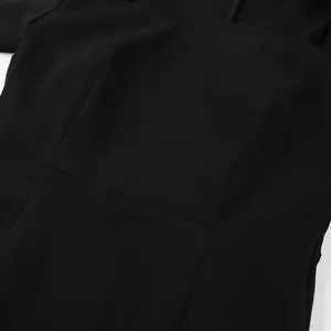 Close-up detail of a French style black dress showing stitching and fabric texture