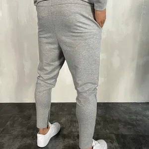 Pantaloni sportivi grigi slim fit da uomo con tessuto traspirante e cerniere alle caviglie