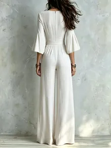 Back view detail of an elegant French-style cream flared sleeve wide-leg jumpsuit with belt
