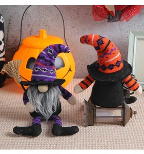 Close-up detail of Halloween gnome dolls featuring tall striped hats and decorative broom props