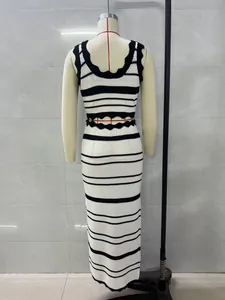Back view of striped knit tank top and high waist maxi skirt two-piece set on mannequin