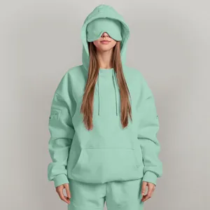 Mint green oversized hoodie with unique built-in eye mask for travel and relaxation