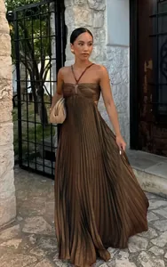 Elegant brown pleated halter maxi dress with a flowing skirt and strapless design