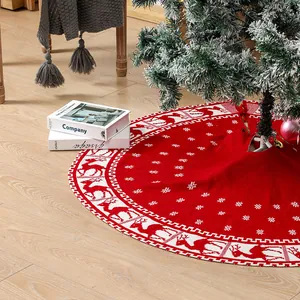 Red knitted Christmas tree skirt with reindeer and snowflake patterns for holiday decor