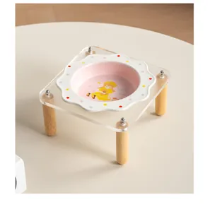Detailed view of flower ceramic pet bowl on clear acrylic stand with wooden legs