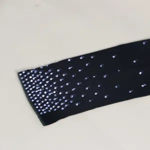Detailed close-up showing silver hot-fix rhinestones on elegant black mesh fabric
