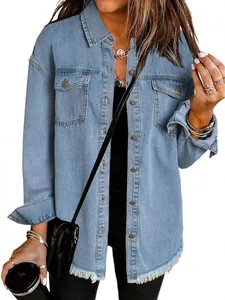 Detail of light wash denim jacket with frayed hem and chest pockets in street style
