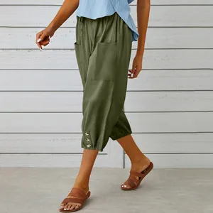 Detail view of olive green cotton linen cropped joggers with side buttons and drawstring waist.