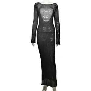 Macro view of sexy black sheer knit maxi dress with long sleeves for beach cover-up