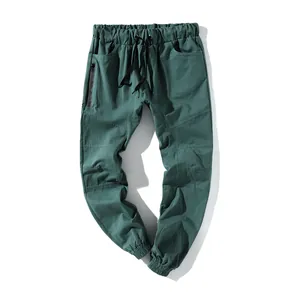 Pantalones cargo verde oscuro para hombre con cintura elástica, cordón y bolsillo con cremallera