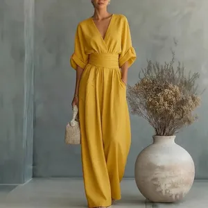 Sophisticated yellow V-neck jumpsuit featuring a cinched waist and wide leg silhouette