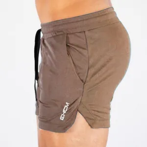 Men's brown quick-dry performance fitness shorts with side split and EHCM logo