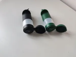 Close-up of black and dark green portable pet waste bag dispensers with liquid storage.