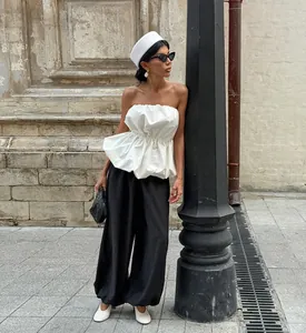 Elegant white puffed strapless tube top with gathered waist for a chic summer look.