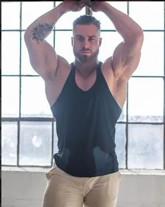 Detailed view of men's black muscle fit gym stringer tank top on athletic model