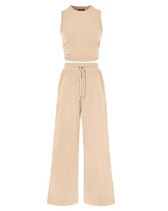 Stylish women's beige 2-piece knit set featuring sleeveless crop top and wide-leg trousers
