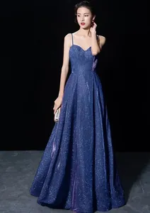 Elegant deep blue glittery evening gown with spaghetti straps and a deep V-neckline.