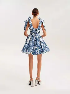 Elegant blue and white floral organza mini dress featuring bow straps and flared skirt