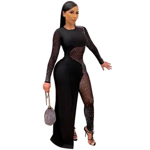 Tuta sexy nera con strass e rete trasparente con gonna spaccata per feste.