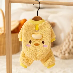 Cozy yellow fleece pet jumpsuit with cute cartoon face on a wooden hanger
