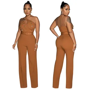 Front and back view of brown one-shoulder jumpsuit with studded detail and belt.
