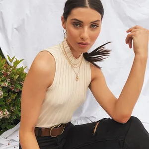 Detailed lifestyle shot of a model wearing a chic beige ribbed knit sleeveless tank top