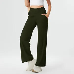 Detail view of dark olive high-waisted yoga pants with pockets and straight leg cut.