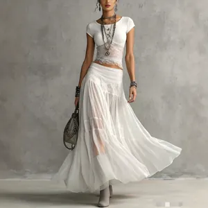 Close-up detail of the elegant white knit top paired with a flowy chiffon maxi skirt