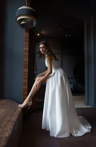 Elegant French style white deep V-neck backless evening gown featuring a high side slit