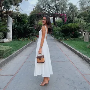 Elegant white square neck sleeveless midi dress for women in a summer garden setting.