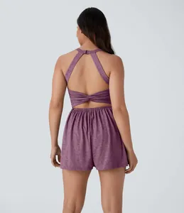 Back view detail of a purple sleeveless open-back halter romper with twisted waist