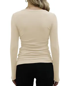 Back view of a minimalist slim fit beige ribbed long sleeve T-shirt for women.