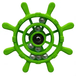 Detail view of a green ship wheel parrot toy featuring rotating silver beads inside