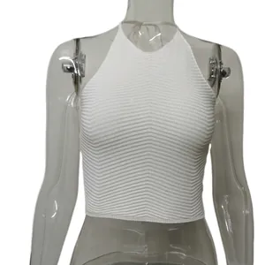 Macro view showing the V-shaped ribbed texture of white knitted halter neck crop top