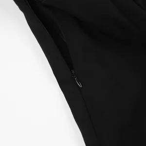 Detail of the hidden side zipper on an elegant French style long-sleeved black dress