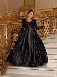 Elegant black deep V-neck evening gown featuring a sequined bodice and satin skirt